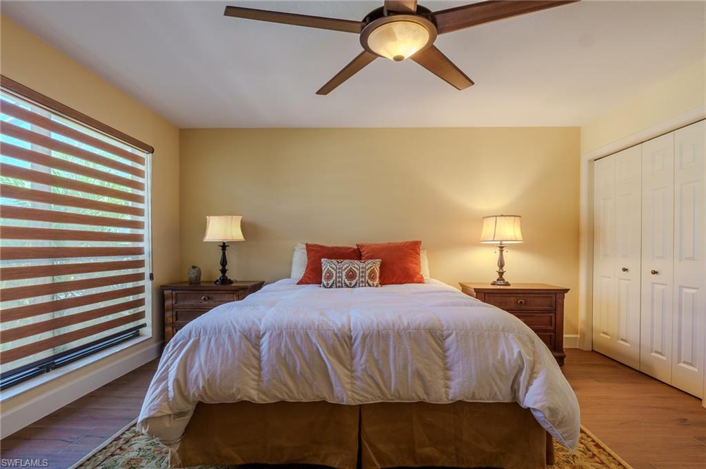 11737 Quail Village Way Naples, FL 34119 - Photo 25 of 50 a bedroom with a bed and lamps