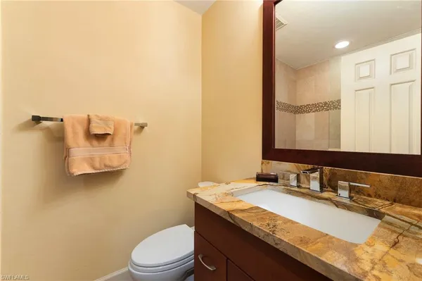 a bedroom with a bed and a ceiling fan