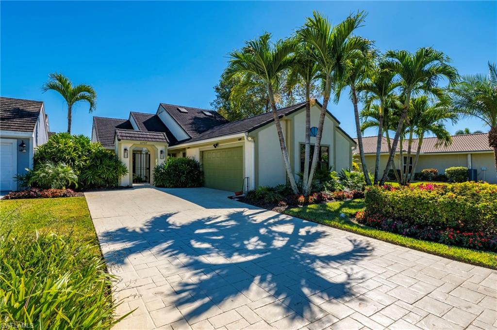 11737 Quail Village Way Naples, FL 34119 - Photo 38 of 50 a house with garden view