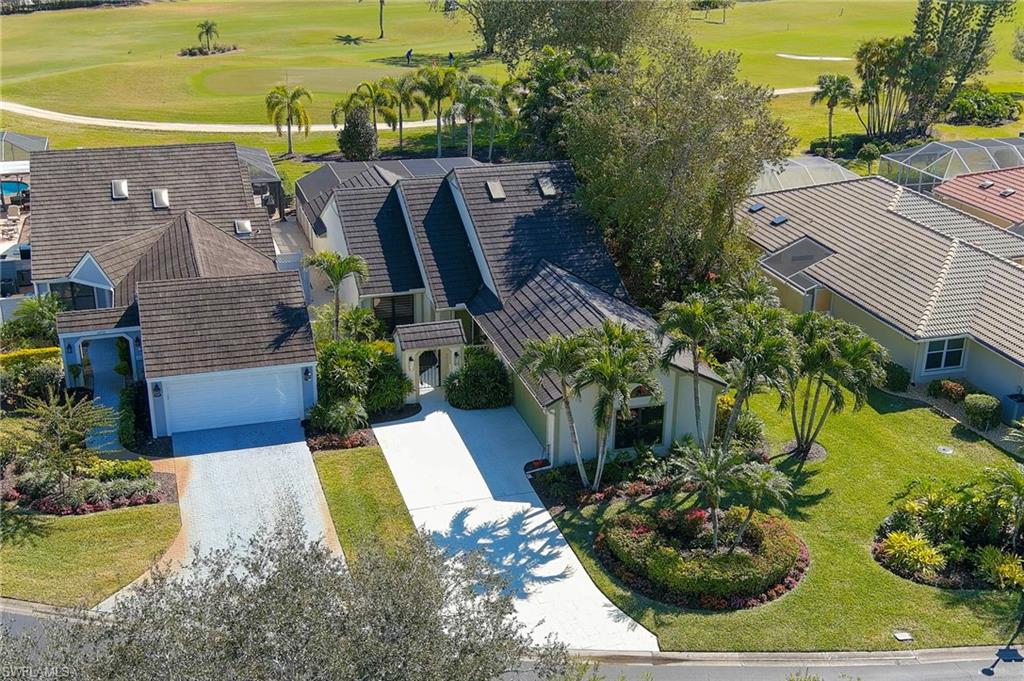 11737 Quail Village Way Naples, FL 34119 - Photo 39 of 50 a view of a house with a yard and potted plants