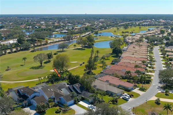 an aerial view of residential houses with outdoor space and lake view