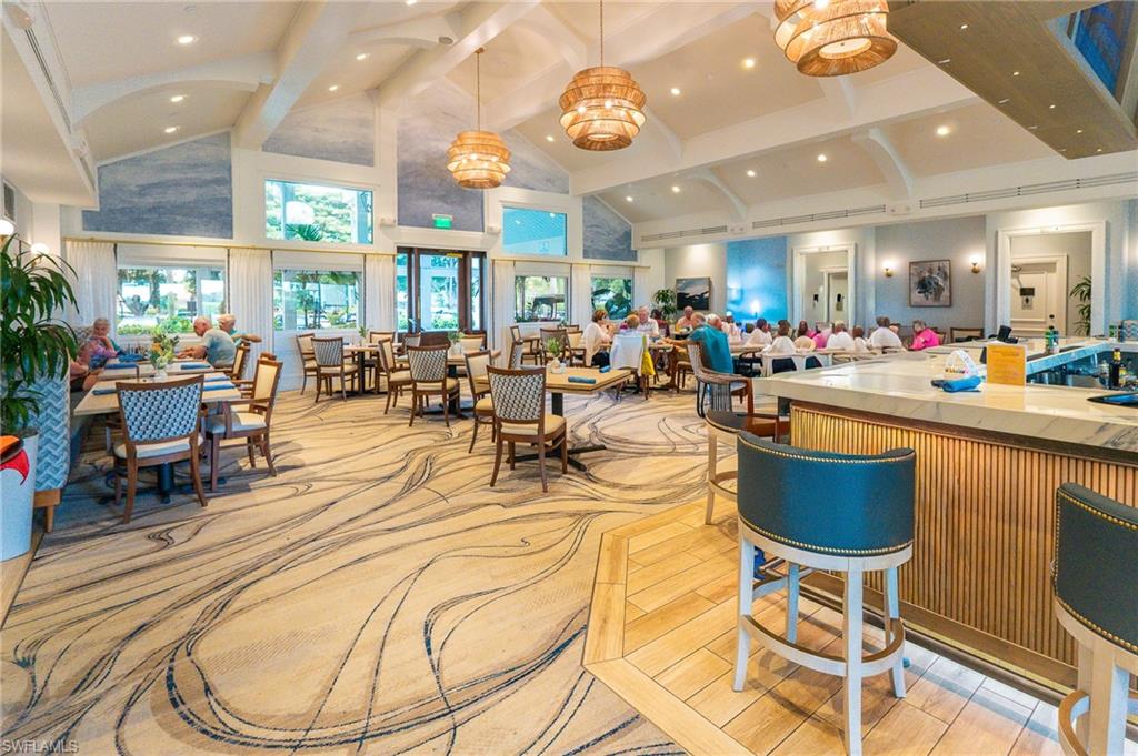 11737 Quail Village Way Naples, FL 34119 - Photo 48 of 50 a view of a dining room with furniture a chandelier and kitchen view