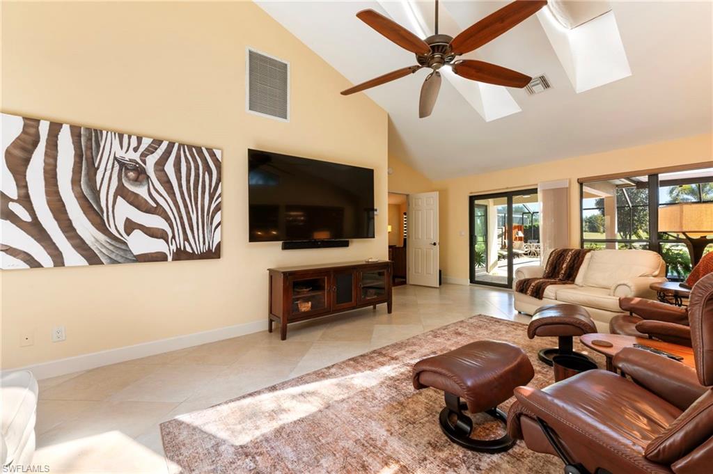 11737 Quail Village Way Naples, FL 34119 - Photo 6 of 50 a living room with furniture and a flat screen tv