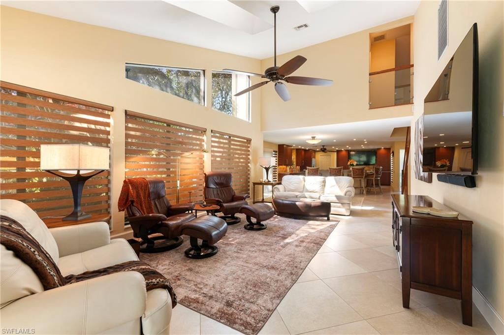 11737 Quail Village Way Naples, FL 34119 - Photo 7 of 50 a living room with furniture kitchen view and large windows