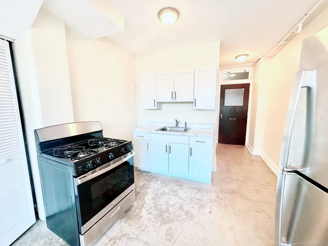 a kitchen with a stove and a refrigerator