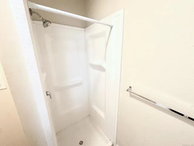 a view of a kitchen with refrigerator and a stove