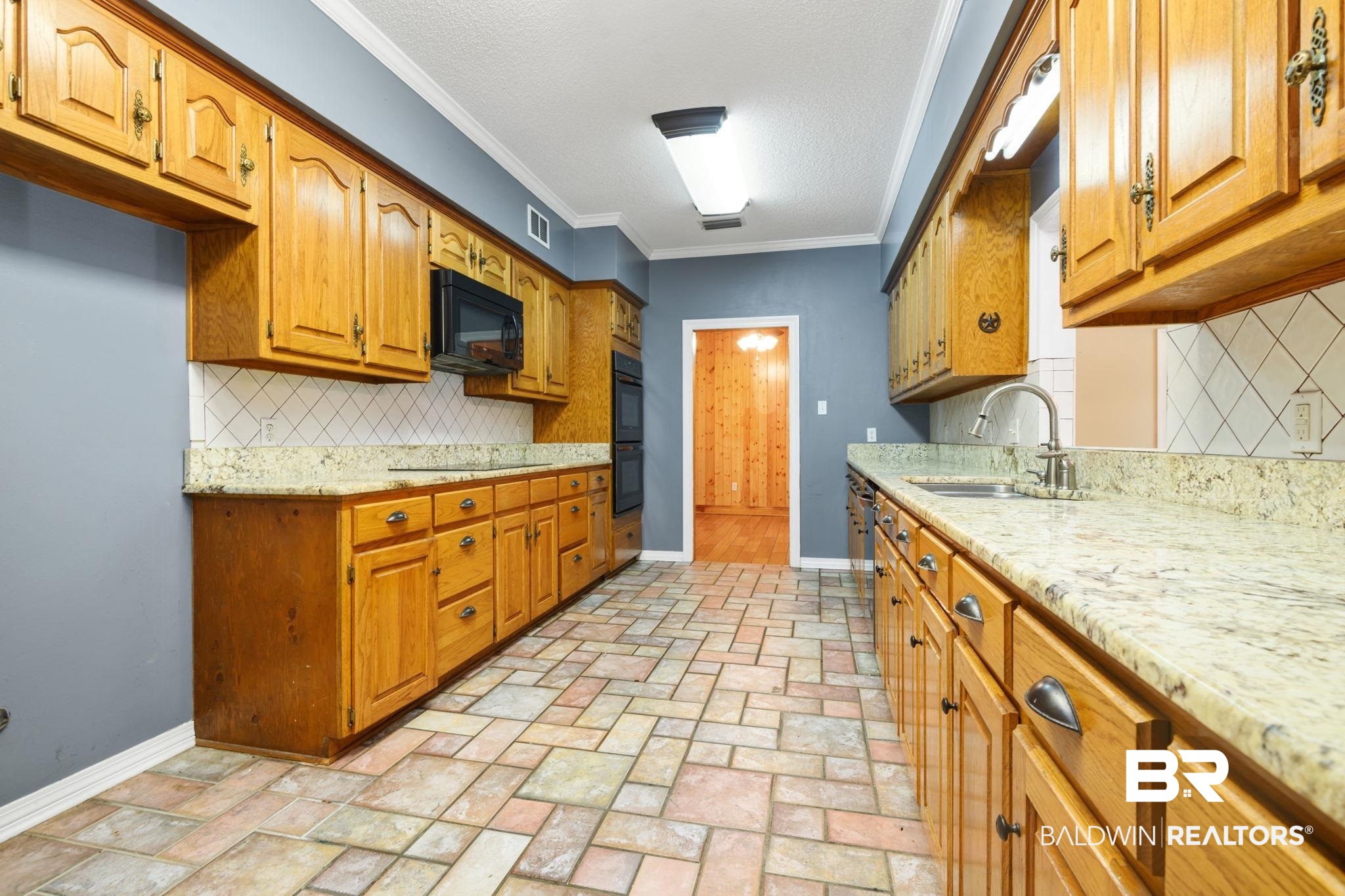 7540 2 Mile Road Irvington, AL 36544 - Photo 23 of 82 Kitchen featuring extensive light wood cabinetry, stone-finish countertops, and a tiled backsplash