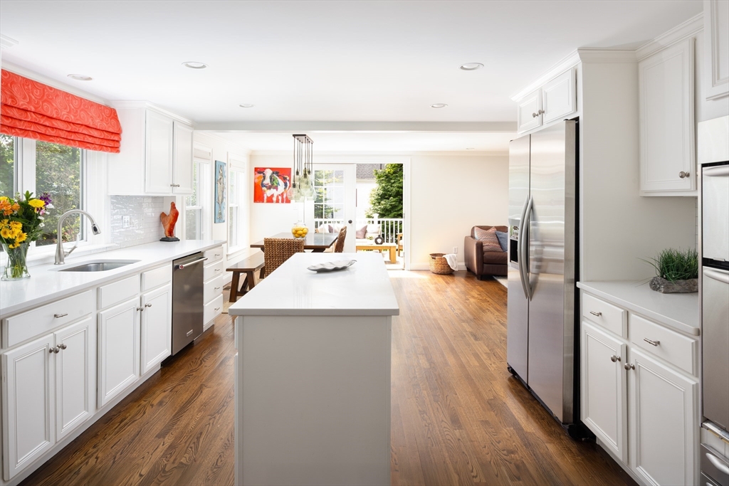 112 Oakdale Road Newton, MA 02461 - Photo 3 of 14 a kitchen with sink a refrigerator and wooden floor