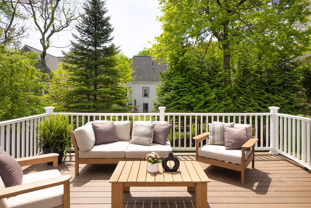 112 Oakdale Road Newton, MA 02461 - Photo 9 of 14 a balcony with wooden floor and outdoor seating
