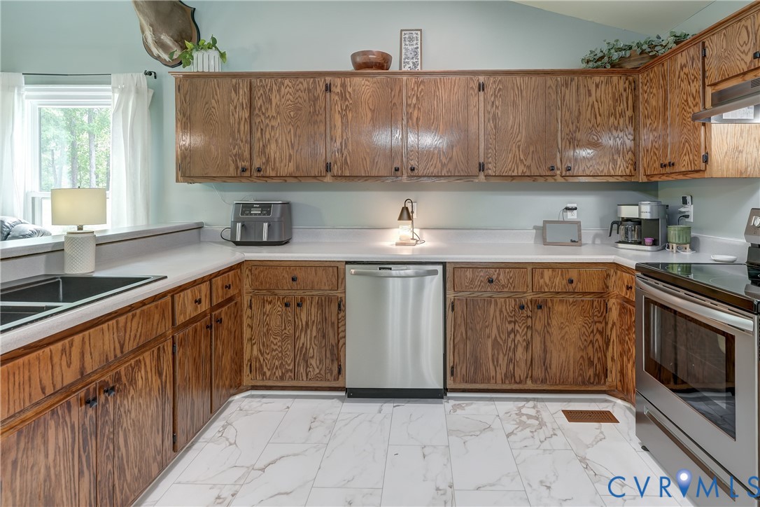 6716 Church Road Petersburg, VA 23803 - Photo 18 of 44 a kitchen with stainless steel appliances granite countertop a sink and a stove