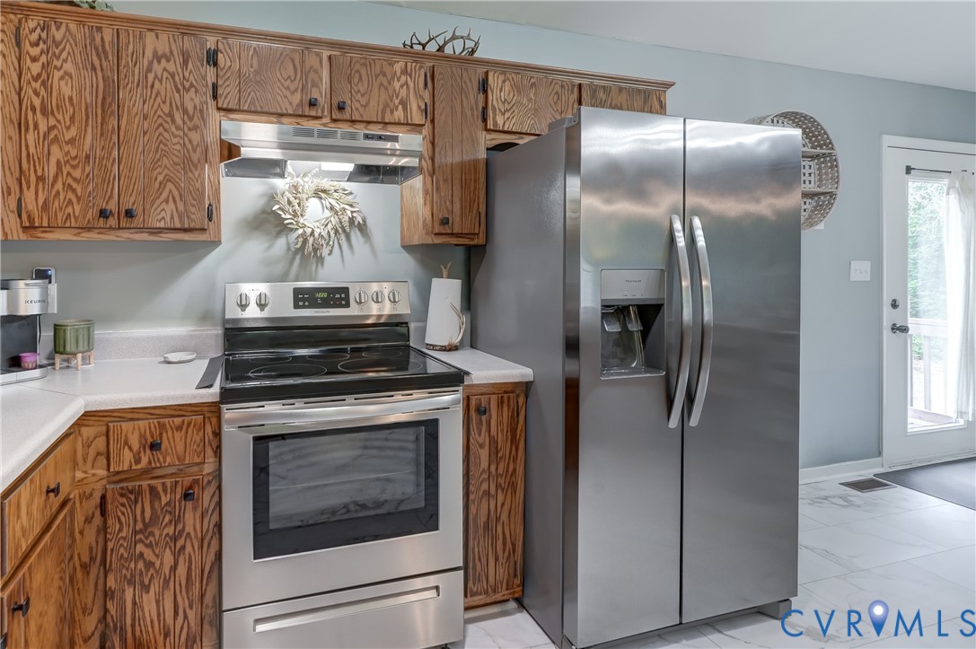 6716 Church Road Petersburg, VA 23803 - Photo 21 of 44 a kitchen with stainless steel appliances granite countertop a stove and a refrigerator