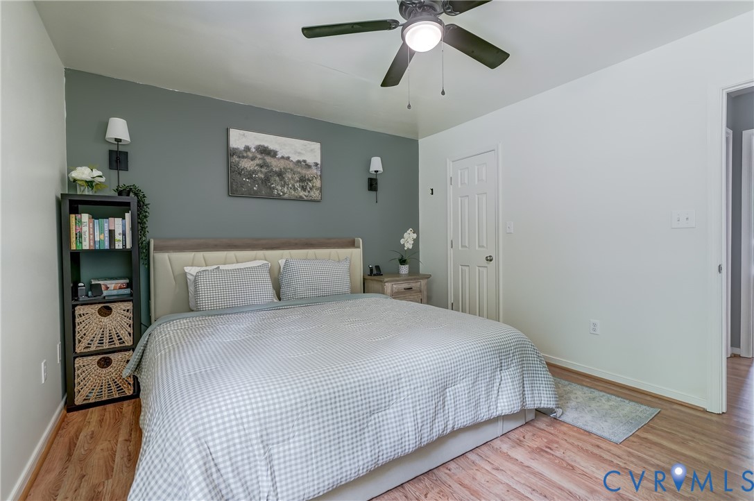 6716 Church Road Petersburg, VA 23803 - Photo 25 of 44 a bedroom with a large bed and a chandelier