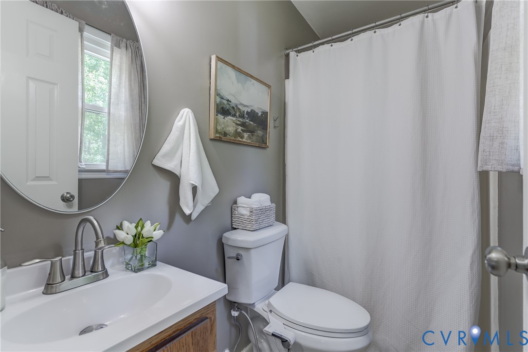 6716 Church Road Petersburg, VA 23803 - Photo 26 of 44 a bathroom with a sink a toilet and a mirror