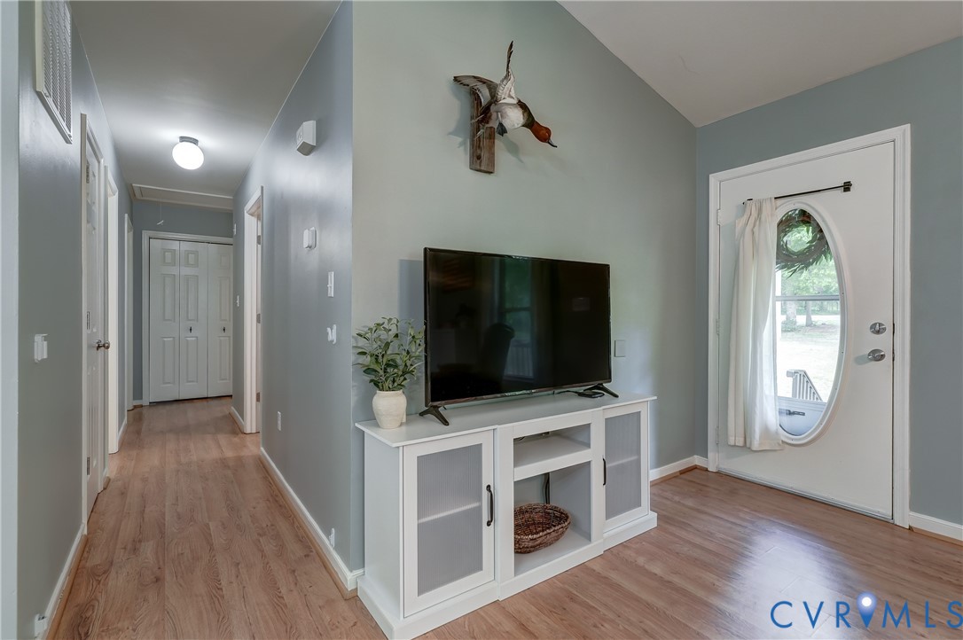6716 Church Road Petersburg, VA 23803 - Photo 10 of 44 a view of a livingroom with wooden floor and a flat screen tv