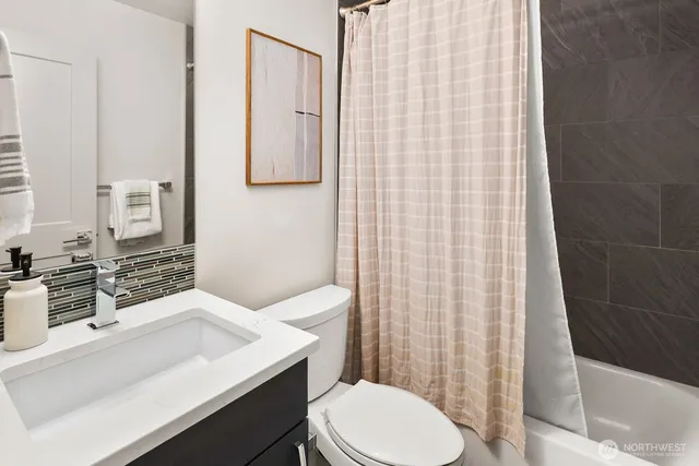 a porch with a table and chairs and potted plants