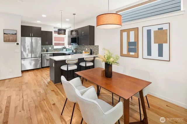 a living room with couches chairs and coffee table with wooden floor