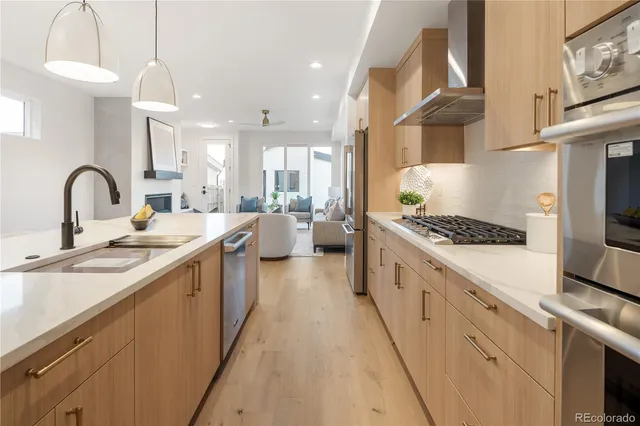 a large kitchen with stainless steel appliances granite countertop a lot of counter space and a sink