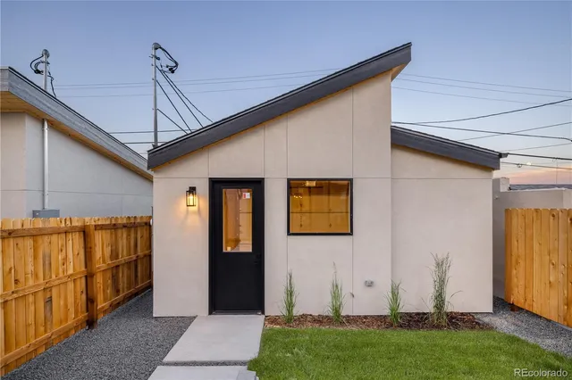 a building outdoor space with patio furniture and potted plants