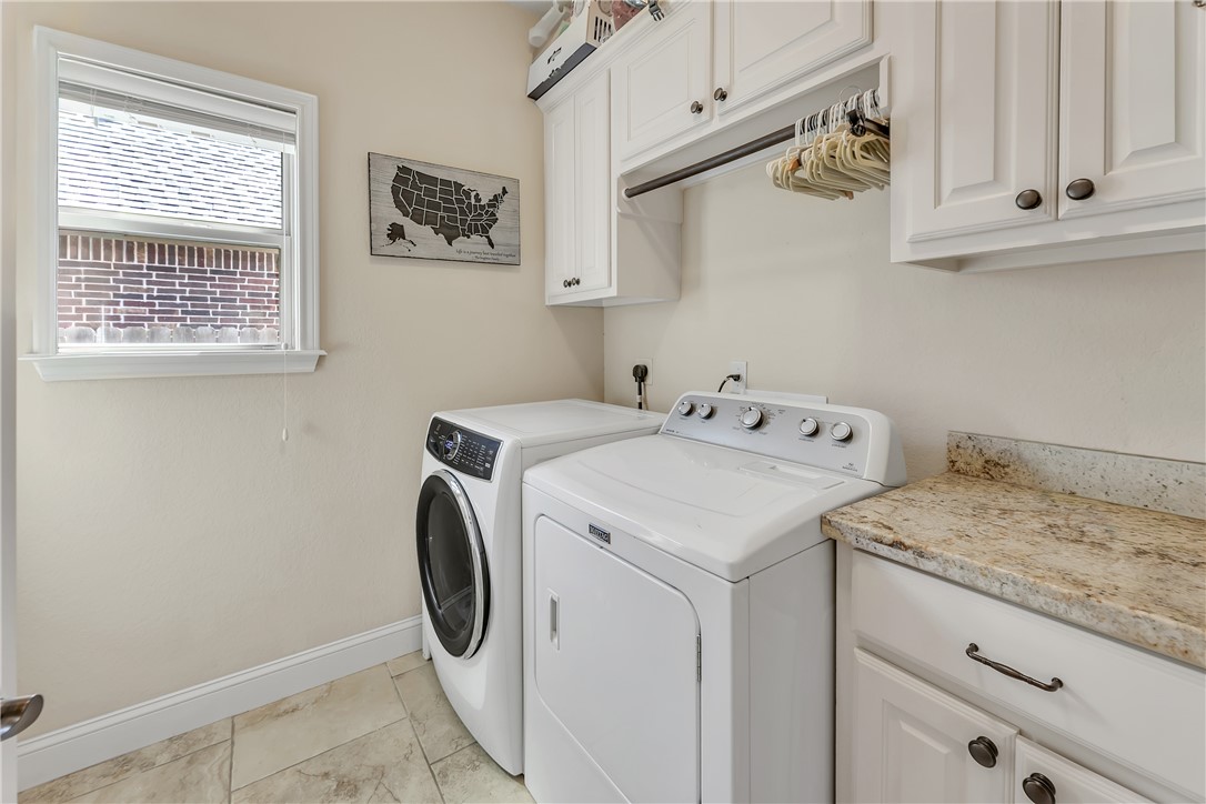 8312 Raintree Drive College Station, TX 77845 - Photo 24 of 30 Laundry area featuring light-colored wall paint and coordinating floor tile