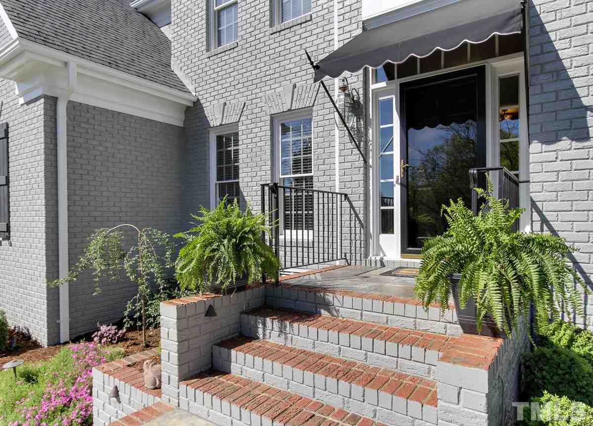7260 Manor Oaks Drive Raleigh, NC 27615 - Photo 2 of 25 New awning covers the front entry welcoming guests into spacious foyer.