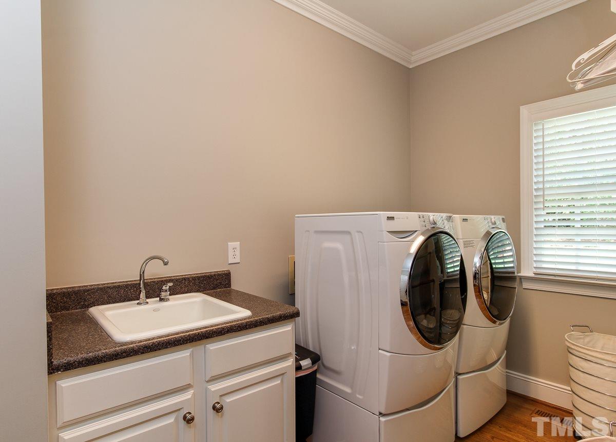 7260 Manor Oaks Drive Raleigh, NC 27615 - Photo 11 of 25 Nice laundry room with window and sink. Great drop zone with hooks and hanging area for clothes.
