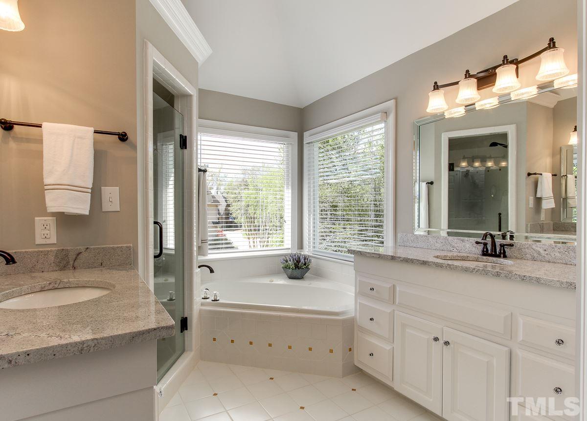 7260 Manor Oaks Drive Raleigh, NC 27615 - Photo 14 of 25 Updated master bath with dual vanities, tub, and shower.