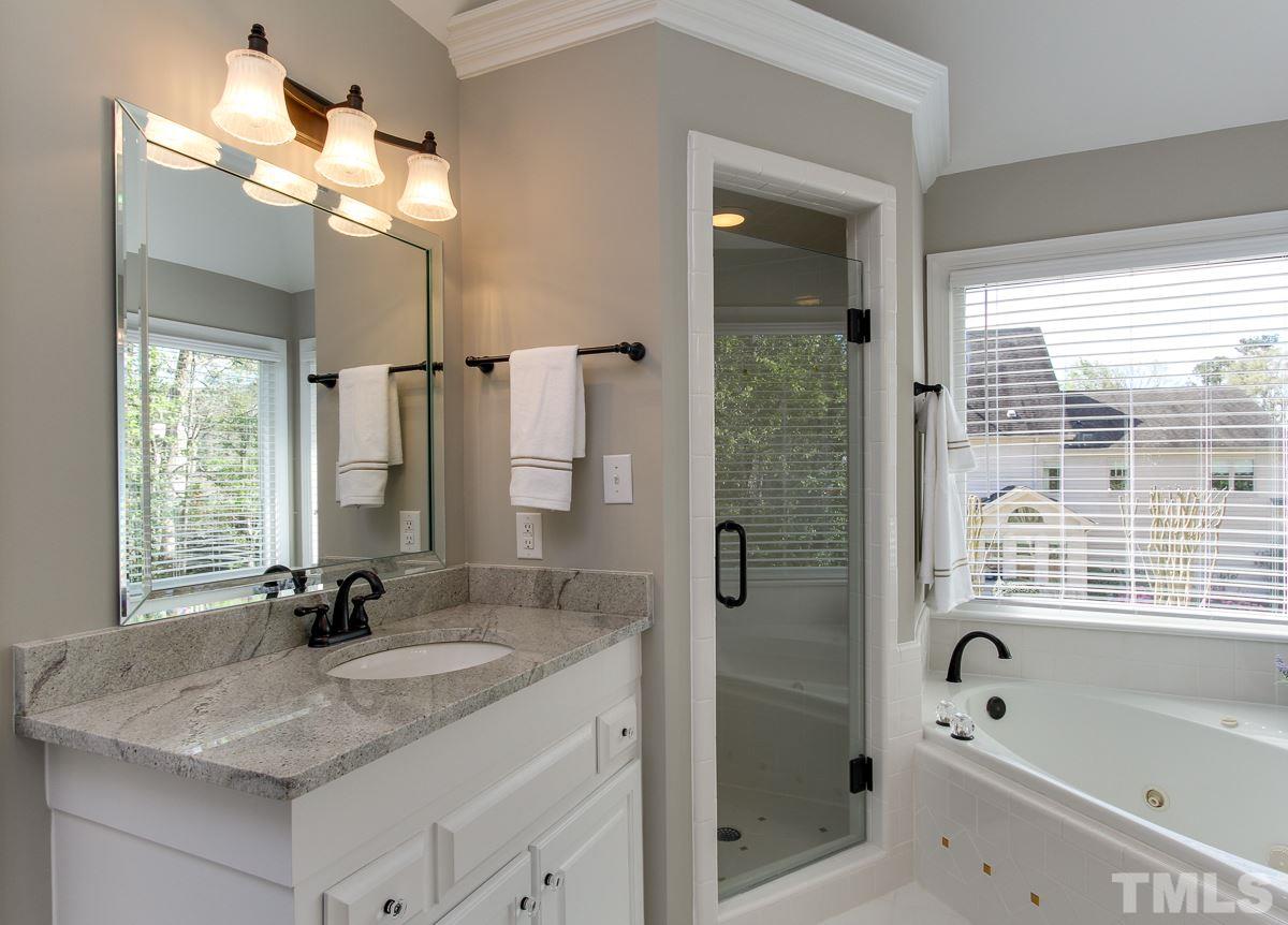7260 Manor Oaks Drive Raleigh, NC 27615 - Photo 15 of 25 Updates include frameless shower enclosure, granite counter tops, and oil rubbed bronze fixtures.