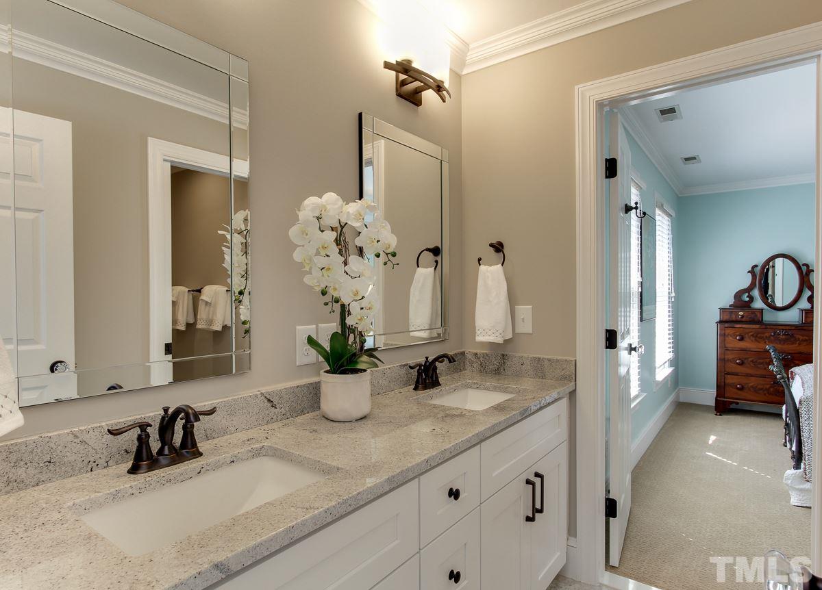7260 Manor Oaks Drive Raleigh, NC 27615 - Photo 19 of 25 The owners just added this bathroom in April 2017 and it is stunning! Marble countertops, double vanity, and a huge walk-in shower with gray and white tile.