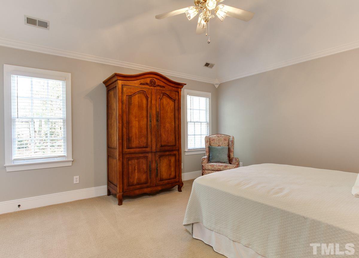 7260 Manor Oaks Drive Raleigh, NC 27615 - Photo 21 of 25 4th bedroom is spacious, has cathedral ceiling, and ceiling fan.