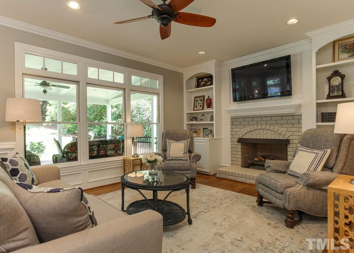 7260 Manor Oaks Drive Raleigh, NC 27615 - Photo 6 of 25 Family room has hardwood floors, built-in cabinetry, and open to kitchen and breakfast room. Large windows overlook new covered porch in back.