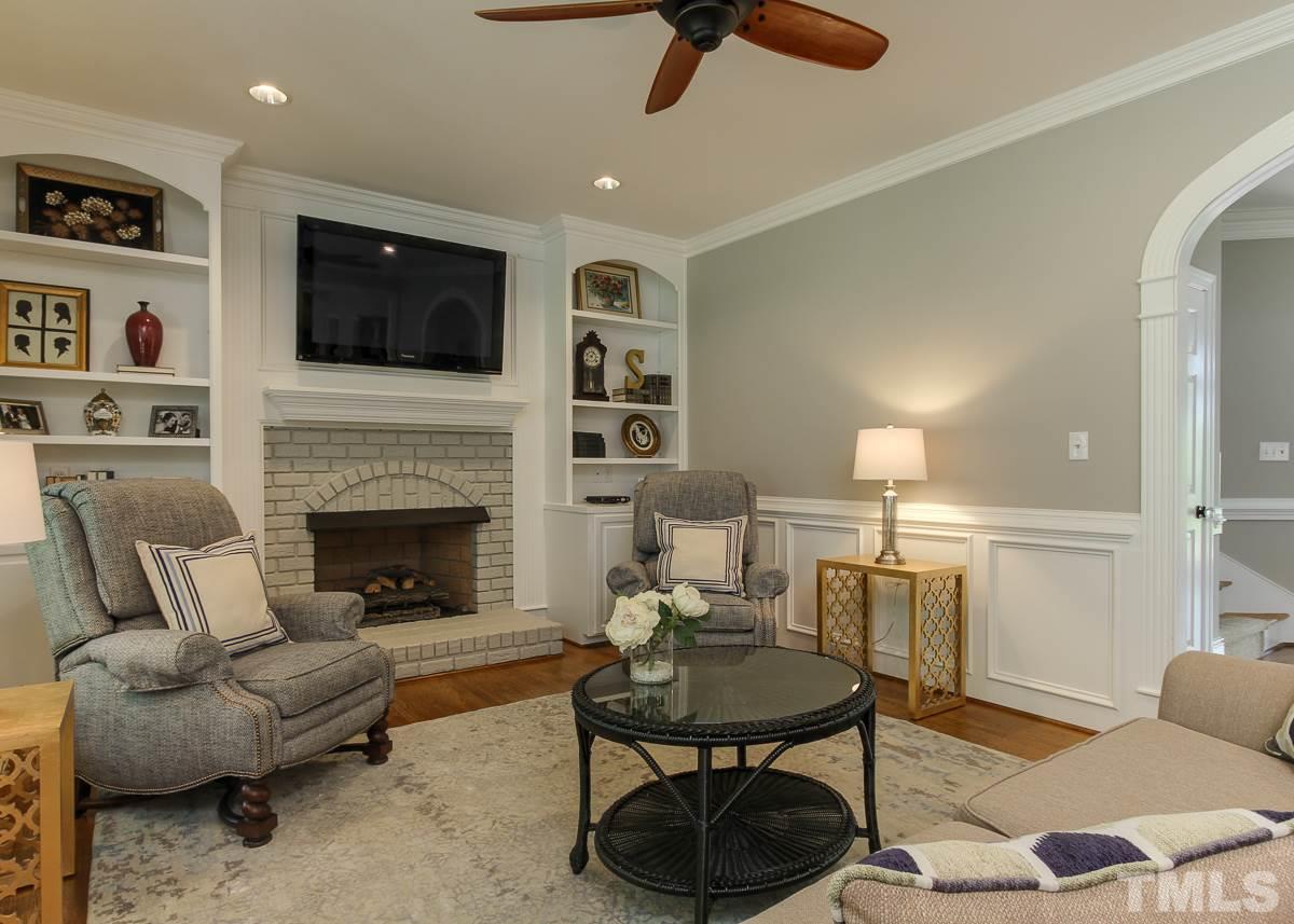 7260 Manor Oaks Drive Raleigh, NC 27615 - Photo 7 of 25 Another view of family room boasts arched entry, wainscoting, and recessed lights with ceiling fan. 9 foot ceilings!