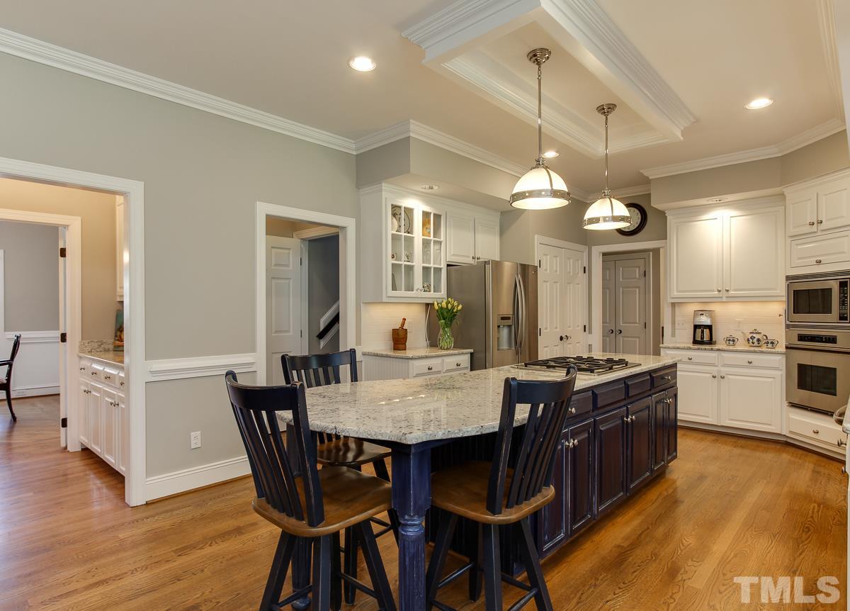 7260 Manor Oaks Drive Raleigh, NC 27615 - Photo 8 of 25 Center island with light granite and cabinetry! Gas cook top and nice stainless steel appliances.
