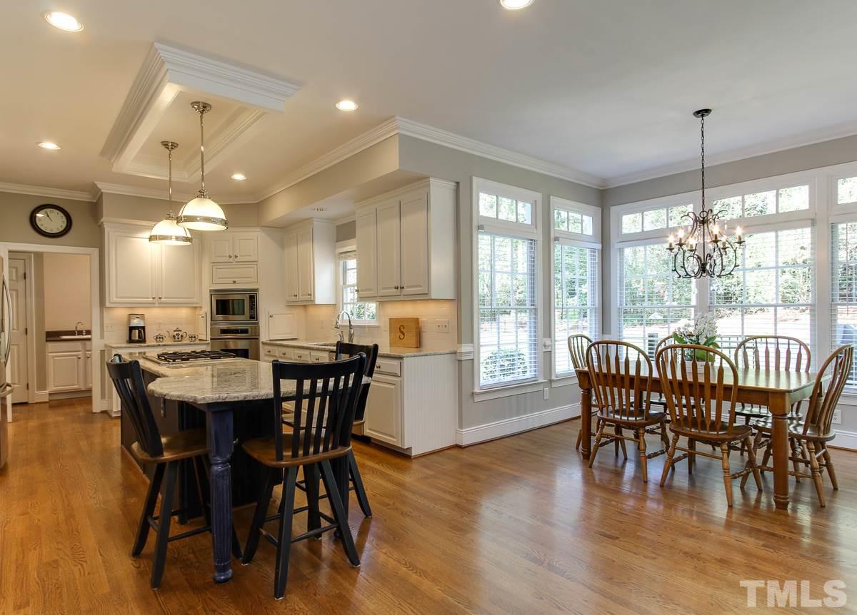 7260 Manor Oaks Drive Raleigh, NC 27615 - Photo 9 of 25 Plenty of natural light in this kitchen. Bar seating and space for large farm table.