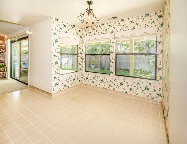 a dining room with stainless steel appliances kitchen island granite countertop a table and chairs