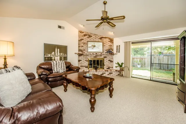 a spacious bedroom with a bed and glass door