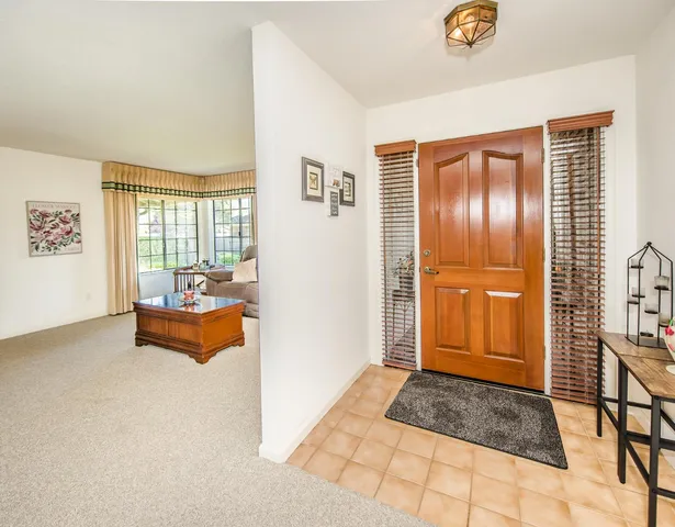 a view of a dining room with furniture and a chandelier