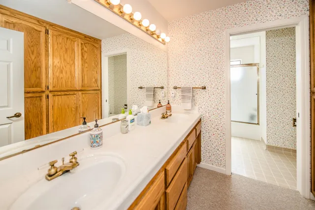 a spacious bedroom with a bed and a chandelier