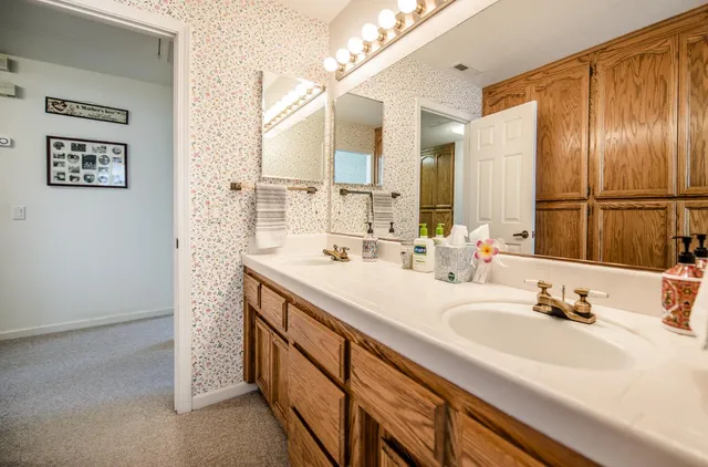 a bathroom with a double vanity sink mirror and