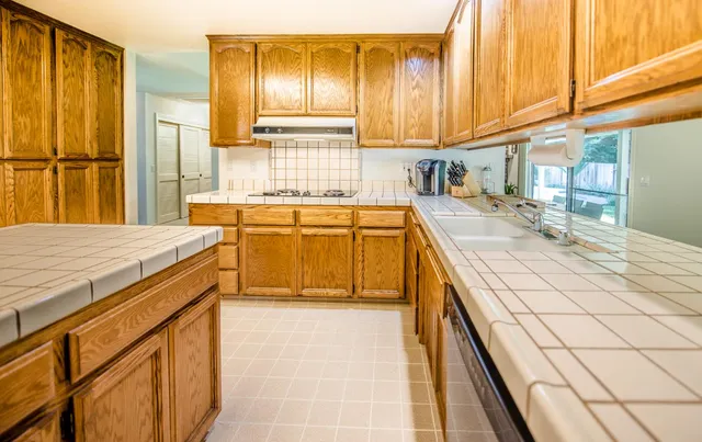 a kitchen with a sink stove and cabinets