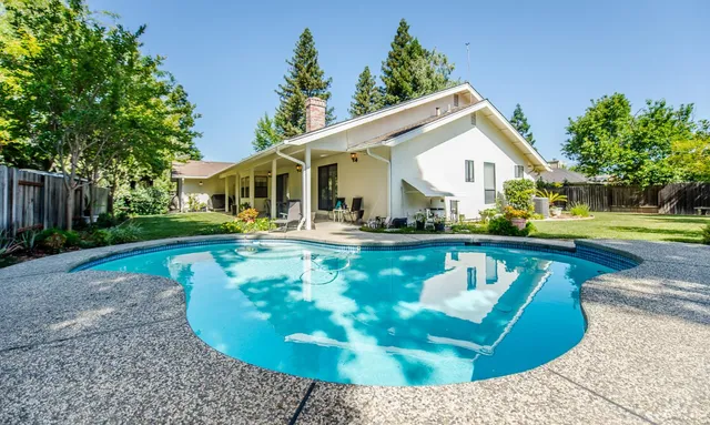 a view of a house with backyard porch and sitting area