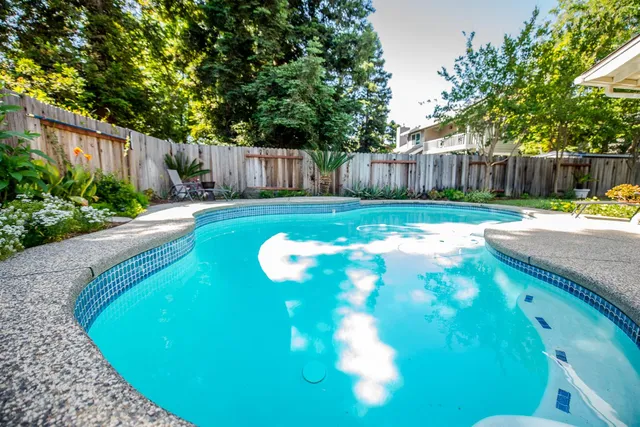 a backyard of a house with table and chairs