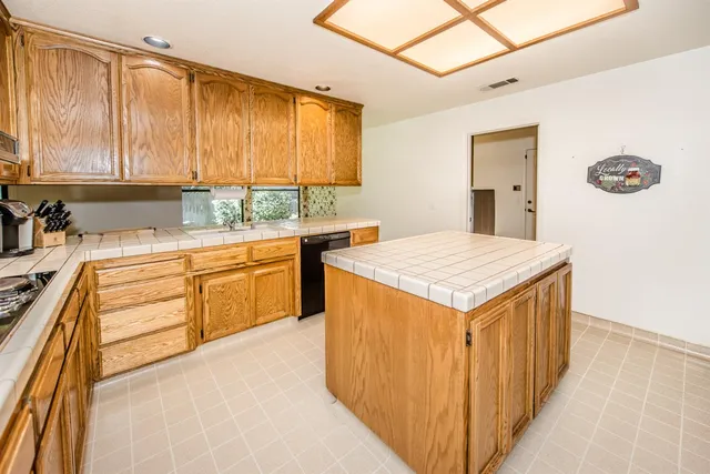 a kitchen with a sink stove and cabinets