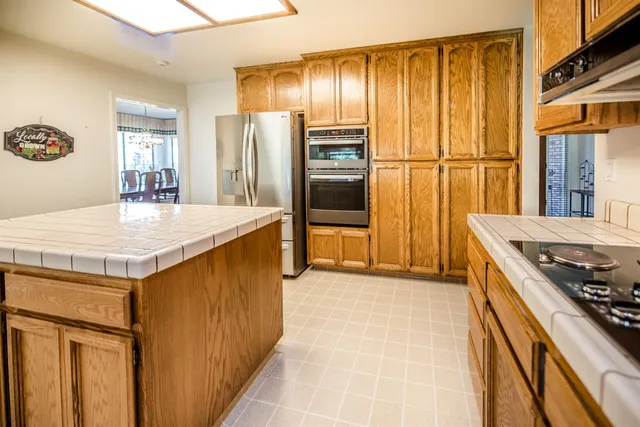 a kitchen with a refrigerator and a stove