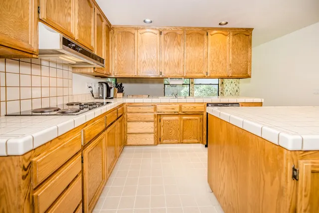 a kitchen with stainless steel appliances granite countertop a sink and cabinets