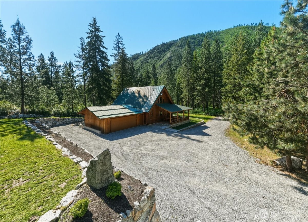 2250 First Crk Road Chelan, WA 98816 - Photo 5 of 39 a backyard of a house with outdoor seating