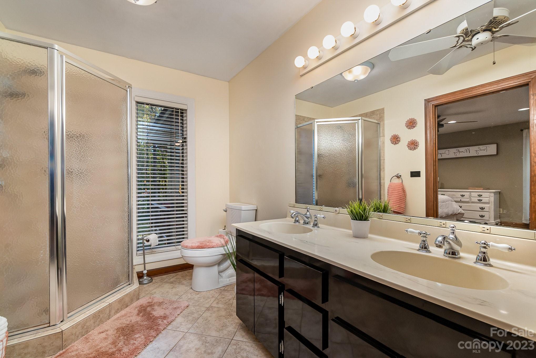 31 Robinwood Drive Midland, NC 28107 - Photo 15 of 33 a bathroom with a double vanity sink toilet and shower
