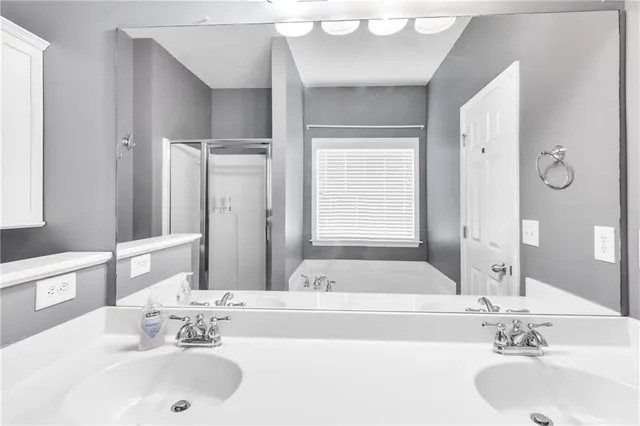 a bathroom with a bathtub sink and a mirror