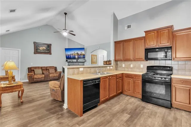 a kitchen with stainless steel appliances granite countertop a stove and cabinets