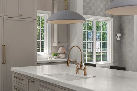 a kitchen with a sink stove and cabinets
