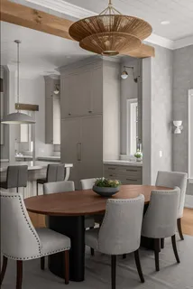 a walk in closet with wooden floor